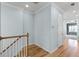 Hallway with wood floors, white trim, and blue walls leads to other rooms, creating an inviting and spacious feel at 5711 Hamlin Groves Trl, Winter Garden, FL 34787