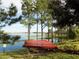 View of Kayaks by a picturesque lake with clear water, surrounded by lush greenery and tall trees at 5711 Hamlin Groves Trl, Winter Garden, FL 34787