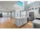 Bright kitchen features a kitchen island, stainless steel appliances, white cabinetry and hardwood floors at 5711 Hamlin Groves Trl, Winter Garden, FL 34787