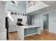 Bright kitchen features a kitchen island, stainless steel appliances, white cabinetry and hardwood floors at 5711 Hamlin Groves Trl, Winter Garden, FL 34787