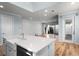 Kitchen features a kitchen island, stainless steel appliances, white cabinetry, hardwood floors and a backyard view at 5711 Hamlin Groves Trl, Winter Garden, FL 34787