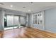 Bright living room with wood floors, board and batten wall and access to the backyard at 5711 Hamlin Groves Trl, Winter Garden, FL 34787