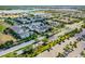 Aerial view of a well-maintained suburban neighborhood with tree-lined streets and beautiful homes in a Gathering-friendly community at 5711 Hamlin Groves Trl, Winter Garden, FL 34787