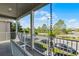 This spacious porch is the perfect place to unwind and take in the beautiful street view, complete with a porch swing at 5711 Hamlin Groves Trl, Winter Garden, FL 34787