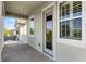 Outdoor porch with swing and view, perfect for relaxing and enjoying the scenery in a comfortable, shaded area at 5711 Hamlin Groves Trl, Winter Garden, FL 34787