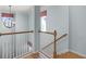 Bright staircase features hardwood steps, white railings, and a decorative light fixture for a warm, inviting ambiance at 5711 Hamlin Groves Trl, Winter Garden, FL 34787