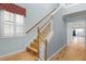 Bright entryway with wood floors and a staircase leading to the upper level at 5711 Hamlin Groves Trl, Winter Garden, FL 34787