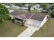 Charming aerial of a single-story home featuring a single-car garage and screened-in porch at 6366 Sw 115Th Street Rd, Ocala, FL 34476