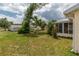 The yard has a chain-link fence, mature trees, and a partial view of the screened lanai at 6366 Sw 115Th Street Rd, Ocala, FL 34476