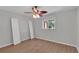Cozy bedroom with wood-look flooring, ceiling fan, and natural light from the window at 6366 Sw 115Th Street Rd, Ocala, FL 34476