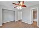 Bedroom featuring ceiling fan, hardwood floors, and view of bathroom at 6366 Sw 115Th Street Rd, Ocala, FL 34476