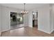 Dining room featuring wood floors and a chandelier with view to the kitchen at 6366 Sw 115Th Street Rd, Ocala, FL 34476