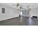 Spacious garage featuring an automatic door opener and a ceiling fan at 6366 Sw 115Th Street Rd, Ocala, FL 34476