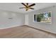 Bright living room with hardwood floors, ceiling fan, and natural light from the window at 6366 Sw 115Th Street Rd, Ocala, FL 34476