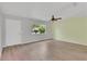 Bright living room with hardwood floors, ceiling fan, and natural light from the window at 6366 Sw 115Th Street Rd, Ocala, FL 34476