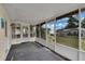 Covered porch with windows offering a view of the backyard at 6366 Sw 115Th Street Rd, Ocala, FL 34476