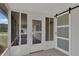 Screened-in porch features sliding door and door with black sliding barn door at 6366 Sw 115Th Street Rd, Ocala, FL 34476