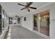 Bright sunroom with sliding doors, glass windows, and vinyl flooring at 6366 Sw 115Th Street Rd, Ocala, FL 34476