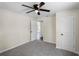 This carpeted bedroom features a ceiling fan and neutral walls at 720 N 6Th St, Haines City, FL 33844