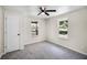 A bright bedroom with neutral walls, two windows and carpet flooring at 720 N 6Th St, Haines City, FL 33844