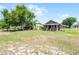 Exterior view of home with a covered porch and large yard at 720 N 6Th St, Haines City, FL 33844
