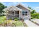 Charming single-story home featuring a cozy front porch with stone accents and a well-maintained lawn at 720 N 6Th St, Haines City, FL 33844