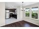 Well-lit kitchen with stainless steel appliances, dark cabinets, and an adjacent dining area with natural light at 720 N 6Th St, Haines City, FL 33844