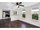 Bright and airy living room with dark wood flooring and a view of the kitchen and backyard at 720 N 6Th St, Haines City, FL 33844