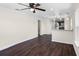 Open-concept living area featuring dark wood floors, a ceiling fan, and a view into the kitchen at 720 N 6Th St, Haines City, FL 33844