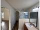 Bathroom with single sink vanity, shower with glass doors, and modern fixtures at 7314 Seena Ct, Orlando, FL 32835