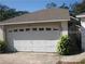 Attached one-car garage with modern door and adjacent front entry at 7314 Seena Ct, Orlando, FL 32835
