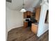 Eat-in kitchen features wood cabinets and black appliances with laminate flooring at 7314 Seena Ct, Orlando, FL 32835