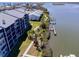Serene aerial view of the property, highlighting the waterfront, boat docks, and well-kept landscaping at 865 Ladyfish Ave # C104, New Smyrna Beach, FL 32169