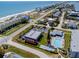 Beautiful aerial view featuring a pool, residential buildings, and beach access at 865 Ladyfish Ave # C104, New Smyrna Beach, FL 32169