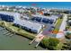 Lovely aerial view showcasing the condo complex, parking, boat ramp, and waterfront access at 865 Ladyfish Ave # C104, New Smyrna Beach, FL 32169