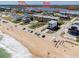 Aerial view of a coastal neighborhood with beach access, a waterfront park, and boat ramp for endless recreation at 865 Ladyfish Ave # C104, New Smyrna Beach, FL 32169