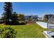 Beautiful backyard with lush green grass, shuffle board and community pool at 865 Ladyfish Ave # C104, New Smyrna Beach, FL 32169