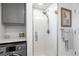 Walk-in shower featuring white subway tile, glass door, and modern fixtures at 865 Ladyfish Ave # C104, New Smyrna Beach, FL 32169