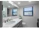 Bright bathroom featuring a quartz countertop, gray vanity, and modern fixtures at 865 Ladyfish Ave # C104, New Smyrna Beach, FL 32169