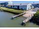 The community boat ramp leading to the water, complemented by lush landscaping and a well-maintained path at 865 Ladyfish Ave # C104, New Smyrna Beach, FL 32169