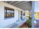 Comfortable condo with a white entrance door, bench, and a staircase at 865 Ladyfish Ave # C104, New Smyrna Beach, FL 32169
