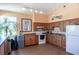 Bright clubhouse kitchen featuring ample counter space, modern appliances, and storage for residents' use at 865 Ladyfish Ave # C104, New Smyrna Beach, FL 32169