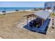 An inviting picnic shelter with tables and grills, perfect for enjoying outdoor meals by the beach at 865 Ladyfish Ave # C104, New Smyrna Beach, FL 32169