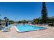 A refreshing swimming pool with lounge chairs and umbrellas, ideal for relaxation and community enjoyment at 865 Ladyfish Ave # C104, New Smyrna Beach, FL 32169