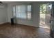 Inviting living room featuring hardwood floors, a window with blinds, and an open entrance at 91 N Triplet Lake Dr, Casselberry, FL 32707