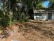 Lush, partially shaded yard showcasing a cozy home exterior with serene, natural surroundings at 91 N Triplet Lake Dr, Casselberry, FL 32707