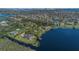 Custom waterfront home nestled on lushly landscaped grounds overlooking a private lake with a boat dock for serene living at 9222 Charles E Limpus Rd, Orlando, FL 32836