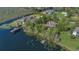Waterfront home featuring a private dock and meticulously maintained lawn; ideal for enjoying serene lakeside living and recreation at 9222 Charles E Limpus Rd, Orlando, FL 32836