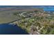 Scenic aerial view of waterfront homes, lush greenery, and a tranquil lake at 9222 Charles E Limpus Rd, Orlando, FL 32836