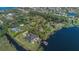 Lakeside home boasts mature trees, offering serene privacy; the covered boat dock enhances the appeal for water enthusiasts at 9222 Charles E Limpus Rd, Orlando, FL 32836